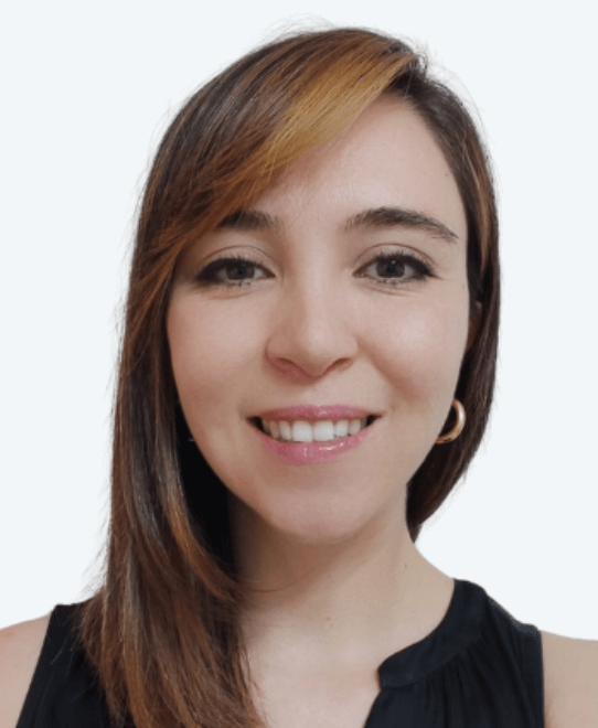 Woman with straight brown hair and a side part, wearing a sleeveless black top and gold hoop earrings, smiles at the camera—a confident member of Team V2 and one of the Tech Leads—against a plain white background.