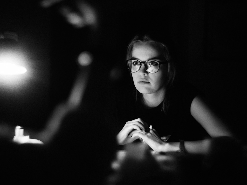 Businesswoman at desk looking at a light image. Photo by Ant Rozetsky on Unsplash.