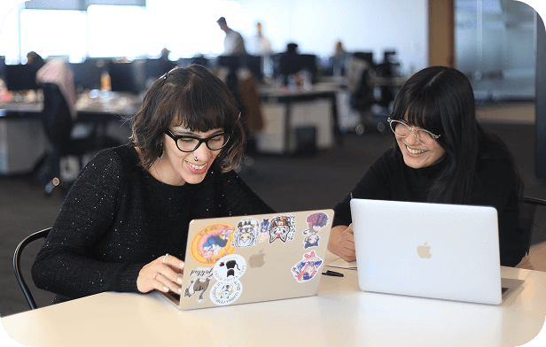 Two girls discuss content solutions to improve SEO