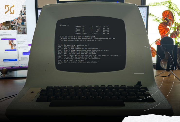 A vintage dumb terminal displaying the ELIZA chatbot program sits on a desk, with modern computer screens and a plant visible in the blurred background.