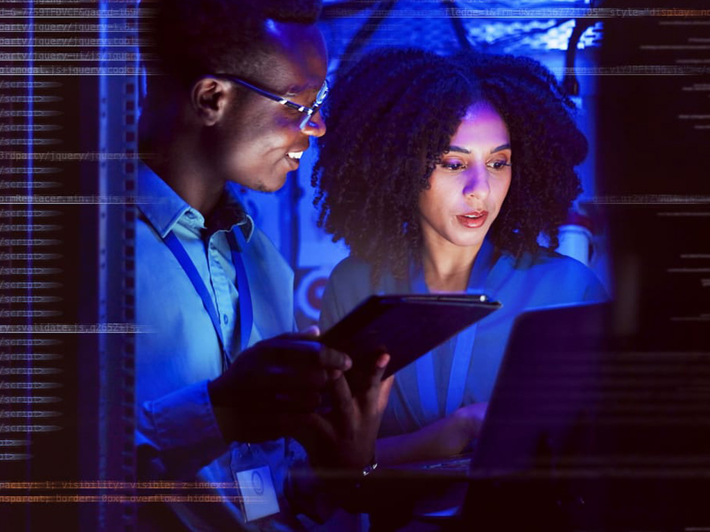 Businessman and businesswoman by data center computer racks image.